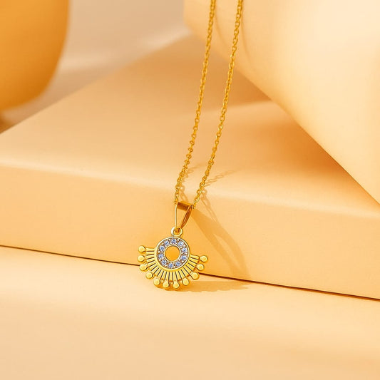 Designer round gold-plated pendant with crystal stones
Ethnic-inspired gold-plated necklace with dotted fan shape
Statement jewellery piece with gold finish and designer pendant
Saiyra radiant pendant necklace for festive or party look
Chic gold necklace with intricate detailing and shine



